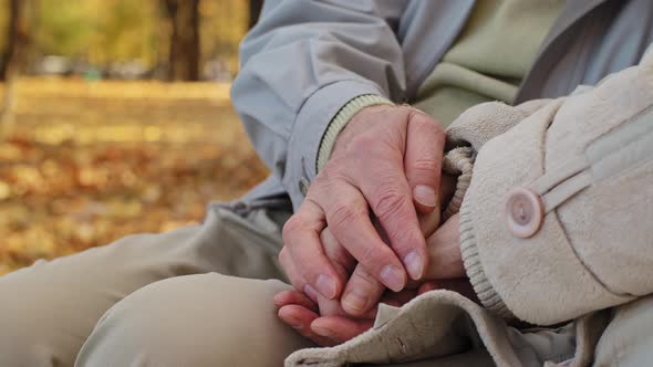 Close Up Wrinkled Hands Elderly Couple Mature Retired Man Husband Stroking Wife on Palm Spend Time