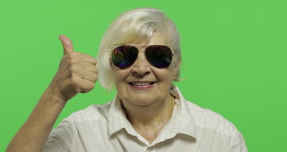An Elderly Woman in Sunglasses Show Thumb Up and Smiles. Chroma Key