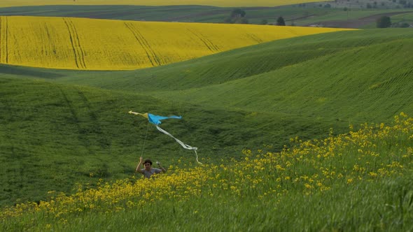 The Boy Launched a Kite and Ran with Him Across the Field