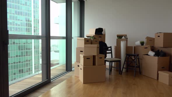 Cardboard Boxes and Chairs in the Interior of an Apartment