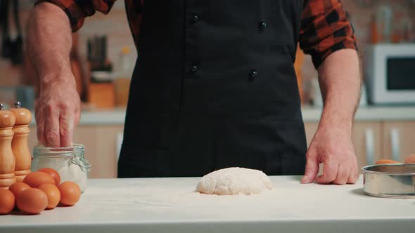 Man Sifting Flour on Dough
