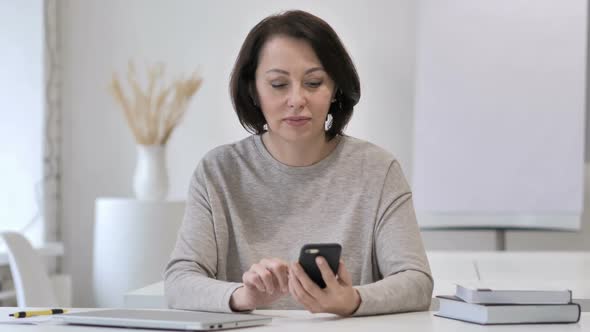 Old Senior Woman Excited for Success While Using Smartphone