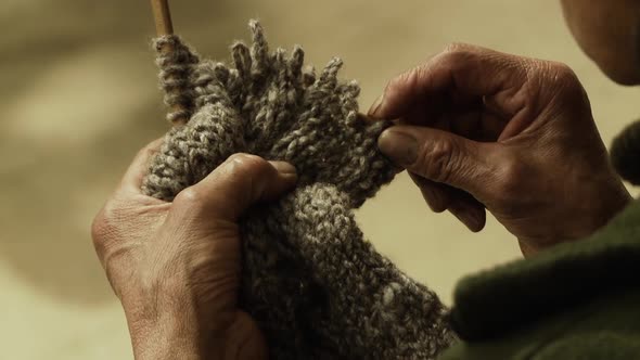 Old Woman doing traditional Artisan Knitting. Slow Motion Shot.