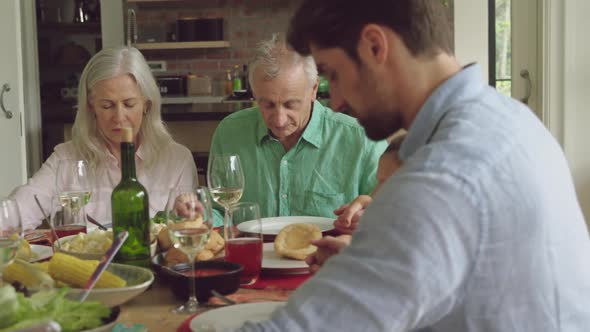 Three generation family eating together