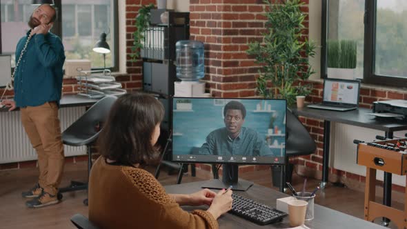 Employee Attending Video Call with Colleague to Work on Project