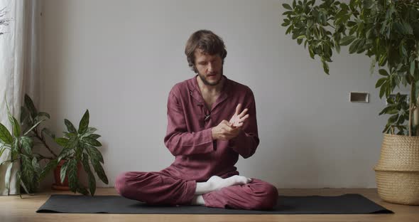 Front View of Thai Masseur on Master Class Demonstrating How To Massage Hand Fingers, Man Sitting