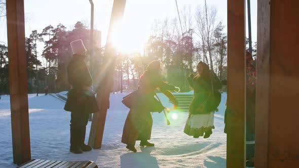 Russian Folk - Woman in a Traditional Costume Is Riding on a Swing in a Winter Park