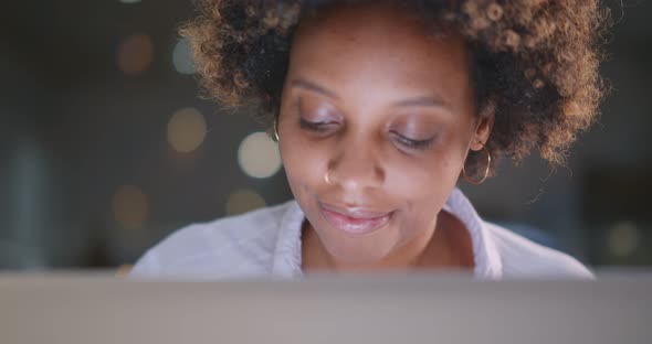 Concentrated Young African Businesswoman Using Laptop in Office