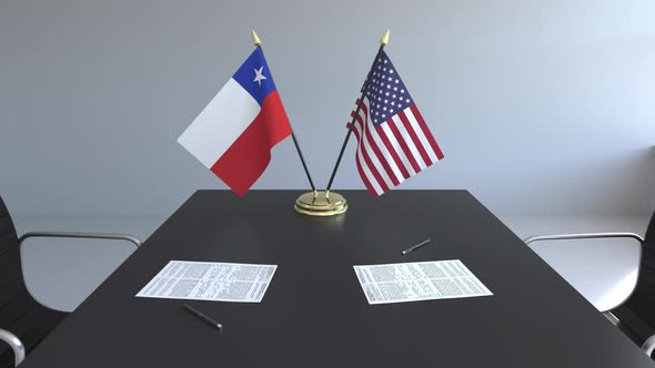 Flags of Chile and the United States and Papers on the Table alt