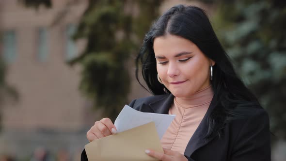 Hispanic Young Woman Sitting on Street Opens Paper Letter Read Good News Beautiful Girl Happy