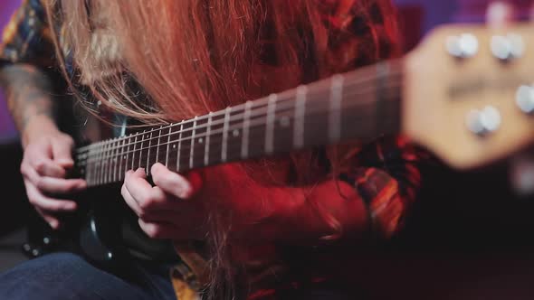 Professional Rock Guitarist Playing Riffs On Electric Guitar At Home Studio With Led Lights