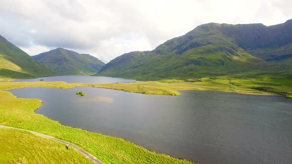 Beautiful mountain range with grassland and lake 4k