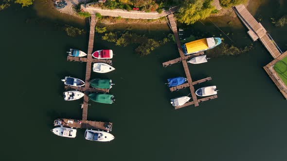 Aerial Top View From the Top on a Small Pier of Motor Boats Located on the River