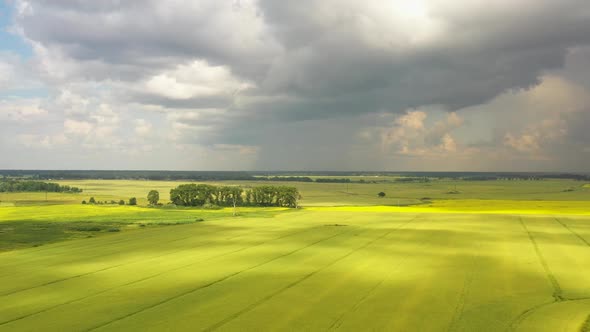 The storm clouds over the agricultural fields, view from a drone