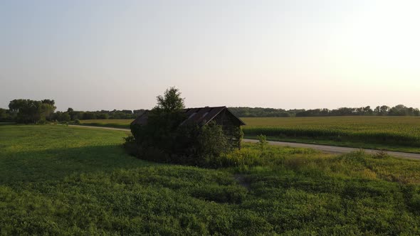 Aerial footage lonely old shack in Minnesota during summer time, farms, country side, fields