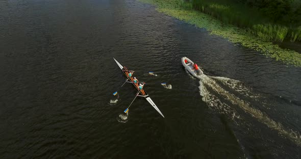 Sports Canoe Driven By Team Men Women Sailing Along Calm River with Sun