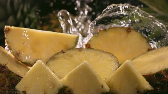 Slow Motion Shot of Pineapple and Water Splashing Through Pineapple Slices