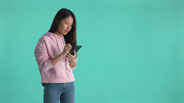 Thoughtful Asian Girl Student Working on Cellphone