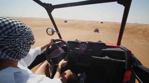 Woman Driving a Sand Dune Buggy in the Desert