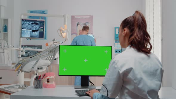 Woman Using Keyboard and Computer with Green Screen