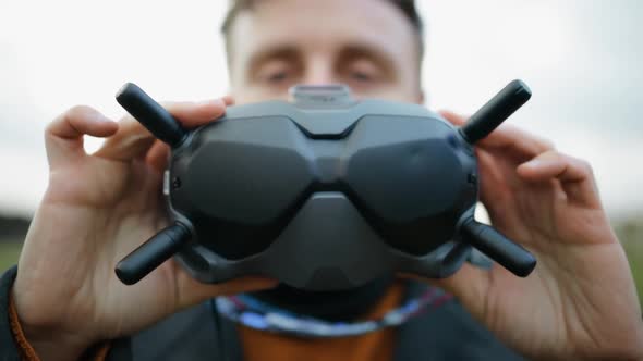Young Man Looking Into Modern FPV Drone Goggles