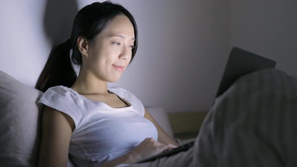 Woman use of laptop computer on bed