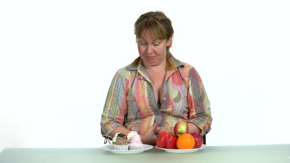 Woman Choosing Between Healthy and Unhealthy Food