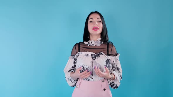 A Woman Gives an Interview on a Blue Background