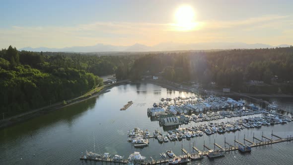 Cinematic dock pier with golden sunset, distant mountains, blue sky, lush green trees, sailboats