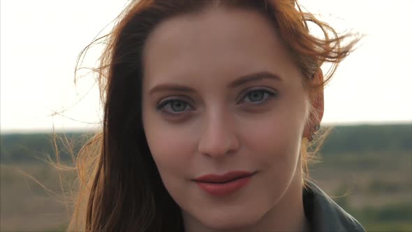 Portrait of a Petty Woman With Red Hair Standing High on a Hill, Girl the Background of Nature