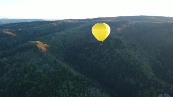 A Balloon Flies Over the Mountains