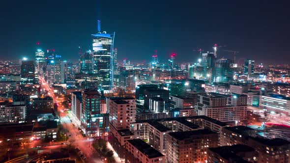 Aerial Hyperlapse of Warsaw Business Center at Night: Skyscrapers and Palace of Science and Culture