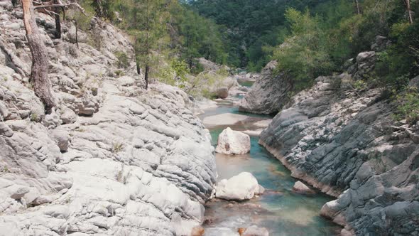 Blue Stream Falling From the Cliffs Surrounded By Forest