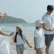 Asian family picking up plastic bottle to trash bag on the outdoor beach. - VideoHive Item for Sale