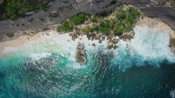 Top Down Aerial View of Azure Blue Water Ocean Waves Crashing on Wild Beach