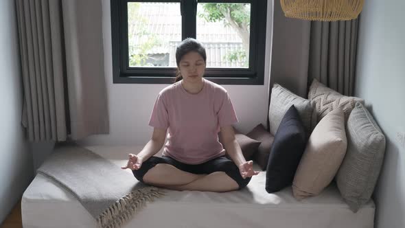 Silhouette of Asian woman practicing yoga meditation