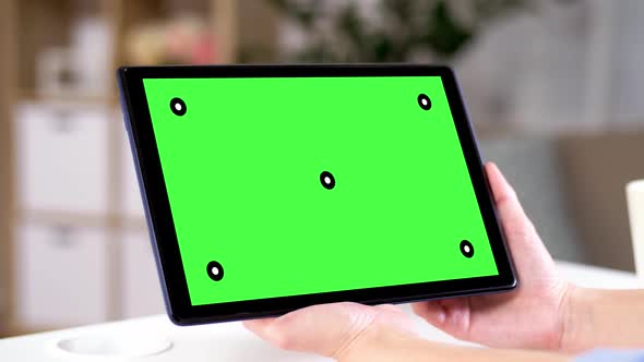 Hands Holding Tablet Pc with Green Screen at Home