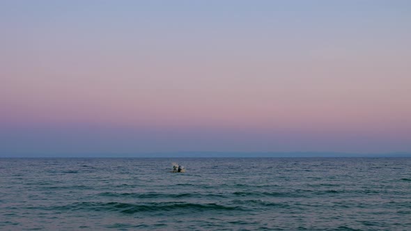 Evening waterscape with lonely boat rocking on sea waves