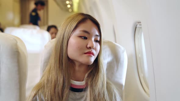 Happy Asian Woman Travel in Airplane