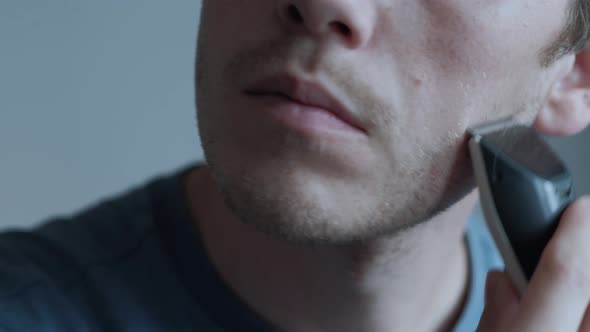 Man Shaving With Electric Razor