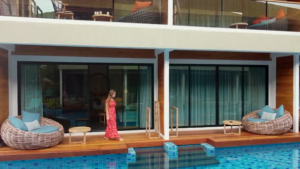 Young Beautiful Woman Coming Out From Hotel Room Directly to Blue Swimming Pool