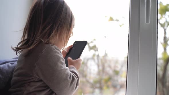 Toddler Child Using Phone at Home, Taking Photos and Playing Games