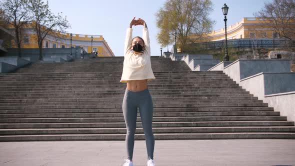 Beautiful Young and Fit Woman Doing Sport Excercises Alone on the Stairs of City Center Area Wearing