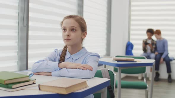 Caucasian School Girl Sitting at Desk