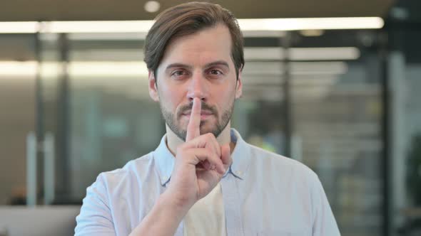 Man Showing Quiet Sign Finger on Lips