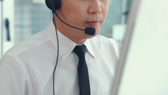 Businessman Wearing Headset Working Actively in Office