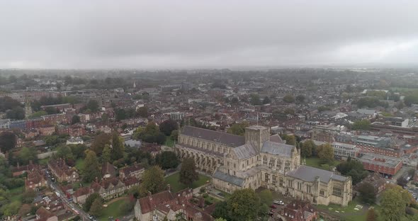 Aerial push in over Winchester Cathedral on a cloudy day