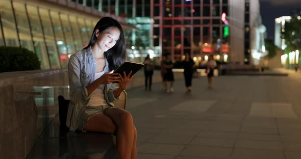 Woman use of digital tablet at night 
