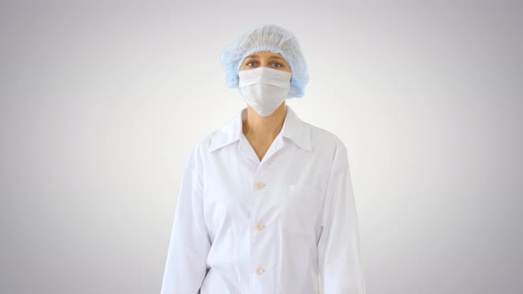 Walking Female Doctor Wearing Surgical Mask on Gradient Background