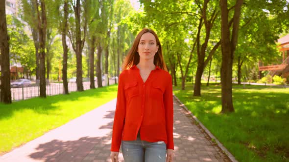 Young Pretty Lady Walking in Summer Park.